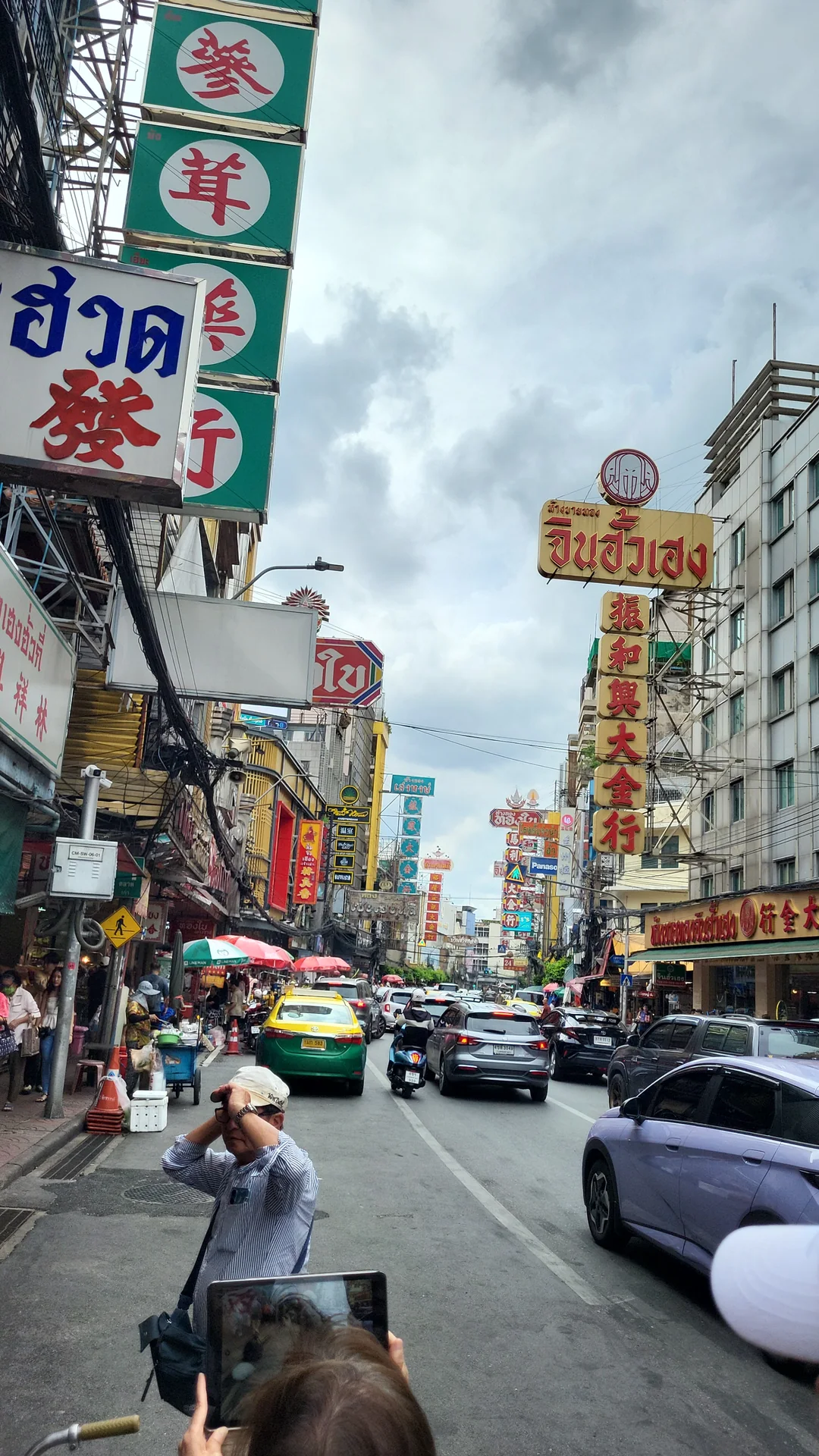 Street scene among the signs and traffic of Bangkok's Chinatown