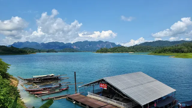 Longtail boats beneath the limestone hills of Khao Sok